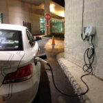 A 2011 BMW ActiveE charging at a public L2 EVSE.  This type of EVSE is “hard-wired” to a fixed location, but L2 EVSE can also be portable. The Society of Automotive Engineers (SAE) didn’t finalize the DCFC standard until 2012, so early EVs like the ActiveE could only be charged using L1 or L2.  Photo Credit: Tom Moloughney