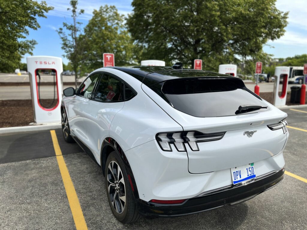 A Ford Mustang Mach-E at a Tesla Supercharging station.