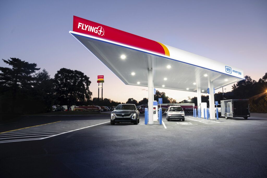 A Cadillac Lyriq, Chevrolet Bolt EUV, and Silverado EV WT charging at a flagship Pilot and Flying J travel center as part of the new coast-to-coast fast-charging network.